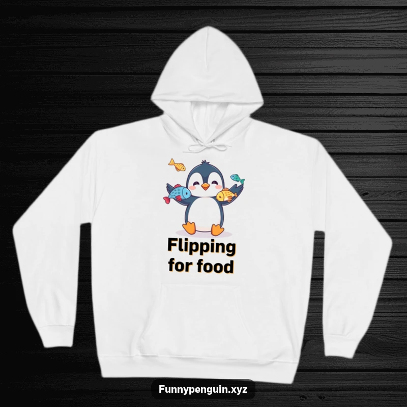 Funny hoodie showing a penguin juggling fish, embodying impressive talent and playful showmanship, an ideal funny gift.
