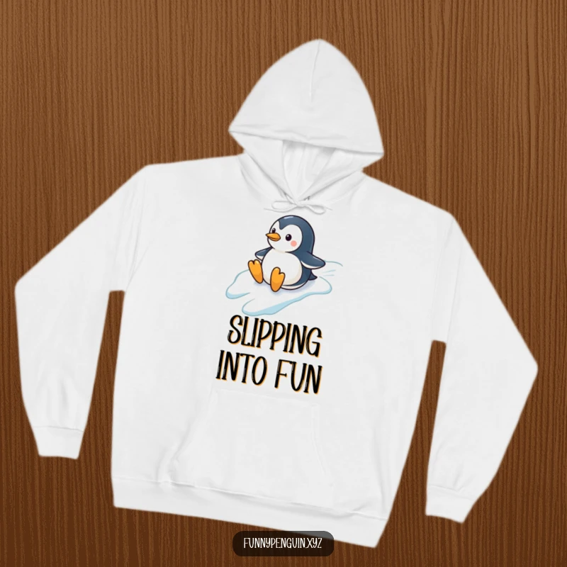 Funny hoodie showing a penguin sliding down a snowy hill, conveying pure winter delight and fun, an ideal funny gift.