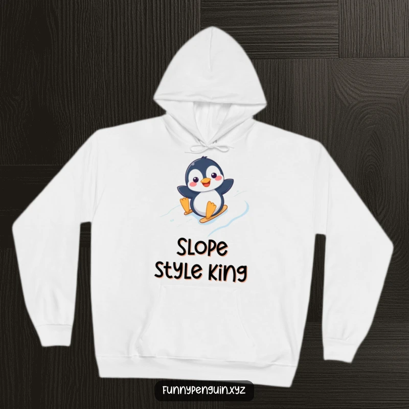 Funny hoodie showing a happy kawaii penguin sliding down an icy slope, perfect for cozy winter days.
