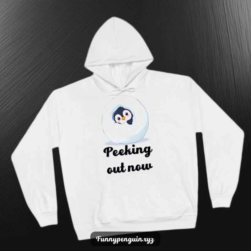 Funny hoodie depicting a curious penguin peeking from behind a snowball, embodying playful mystery and warmth, an ideal funny gift.