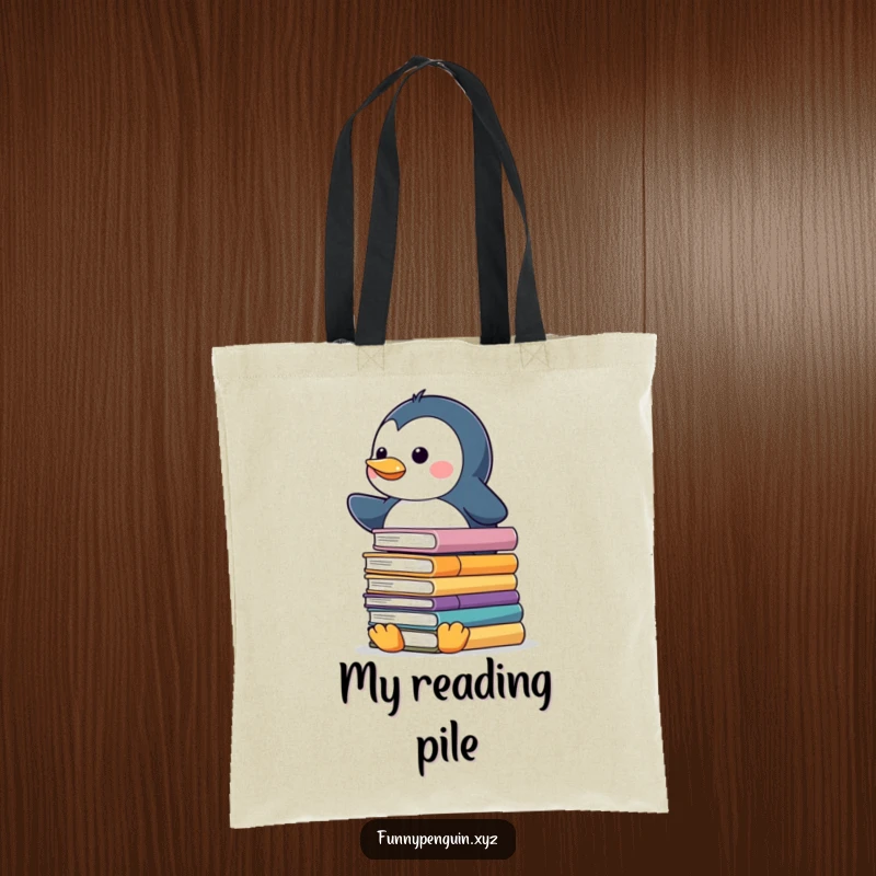 Funny tote bag featuring a kawaii penguin balancing a tall stack of slippery books, perfect for carrying study materials.